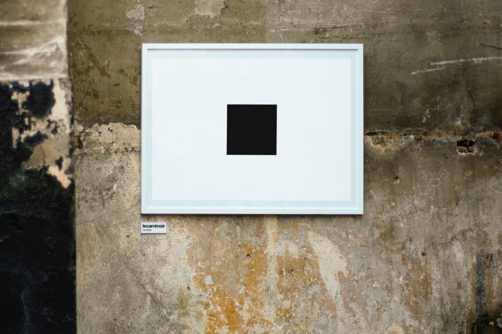 Black square on a white background displayed on a bare concrete wall.