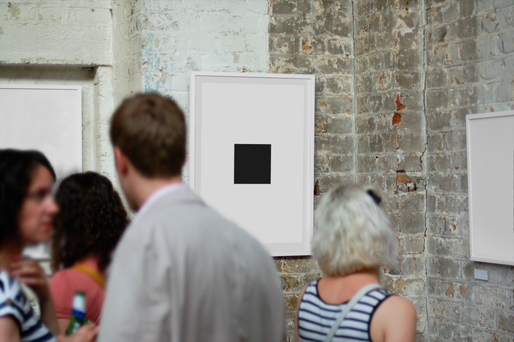 Black square on a white background displayed on a gallery wall, surrounded by people.